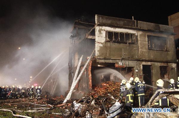 Firefighters are seen at an explosion site in Xinbei City, southeast China&apos;s Taiwan, April 22, 2011. An explosion at a paper mill occurred Friday evening in Xinbei City of Taiwan, leaving at least 4 people dead and another 33 injured.[Xinhua]