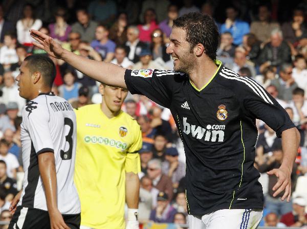 Real Madrid's Higuain celebrates after he scored a goal against Valencia during their Spanish first division soccer match at the Mestalla Stadium in Valencia April 23, 2011. Real Madrid won 6-3. (Xinhua/Reuters Photo)   