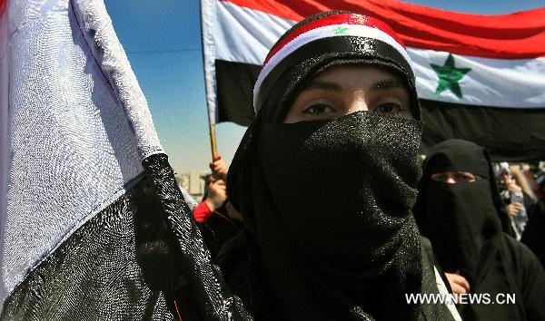A Syrian female protester participates in a demonstration attended by Syrians living in Jordan against Bashar's government and the ruling Baath Party in front of Syrian embassy in Amman, capital of Jordan, on April 24, 2011. [Mohammad Abu Ghosh/Xinhua] 