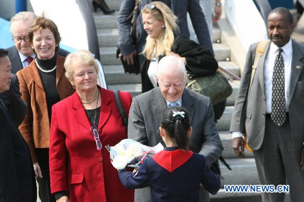 Former U.S. President Jimmy Carter (C) arrives at the airport of Pyongyang, capital of the Democratic People's Republic of Korea (DPRK), April 26, 2011. Carter arrived in Pyongyang for a three-day visit at easing tensions on the Korean Peninsula. [Zhao Zhan/Xinhua]