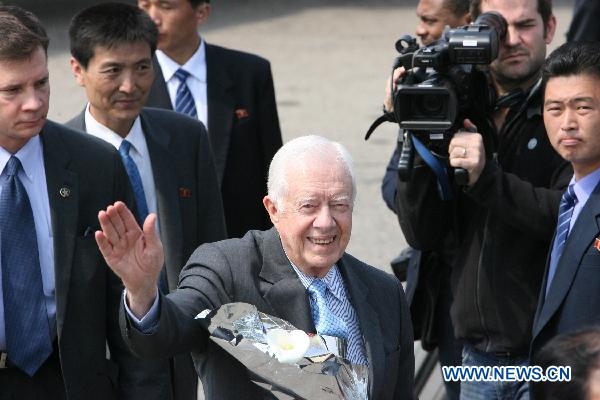 Former U.S. President Jimmy Carter (C) arrives at the airport of Pyongyang, capital of the Democratic People's Republic of Korea (DPRK), April 26, 2011. Carter arrived in Pyongyang for a three-day visit at easing tensions on the Korean Peninsula. [Zhao Zhan/Xinhua]