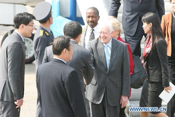 Former U.S. President Jimmy Carter(C) is greeted by Ri Yong Ho, Vice Foreign Minister of the Democratic People's Republic of Korea (DPRK) at the airport of Pyongyang, capital of the DPRK, April 26, 2011. Carter arrived in Pyongyang for a three-day visit at easing tensions on the Korean Peninsula. [Zhao Zhan/Xinhua]