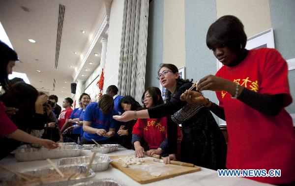 Canada's Chinese language learners and teachers make dumplings in a gala at the Embassy of the People' s Republic of China in Ottawa, Ontario, Canada, on April 23, 2011. Some 200 students and their teachers from eastern Canada performed traditional and modern Chinese songs, danced, played traditional Chinese instruments, recited poetry and enjoyed Chinese food Saturday together at China's Embassy to Canada. [Christopher Pike/Xinhua]