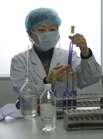 A worker tests and determines water samples in the water monitoring center in Yilan County, Heilongjiang Province, on April 24, 2011. 