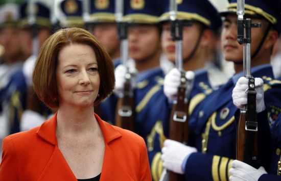 Australian Prime Minister Julia Gillard walks with Chinese Premier Wen Jiabao (unseen) as they inspect an honour guard during an official welcoming ceremony in the Great Hall of the People in Beijing April 26, 2011.
