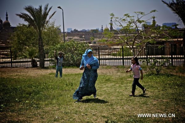 People play on grass during the traditional festival &apos;the Day of Beneficial Wind&apos; in Cairo, Egypt, April 25, 2011.