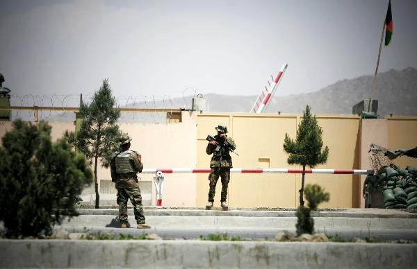 Afghan National Army soldiers stand guard outside an airport gate in Kabul, after a shooting incident on April 27, 2011. [Ahmad Massoud/Xinhua]