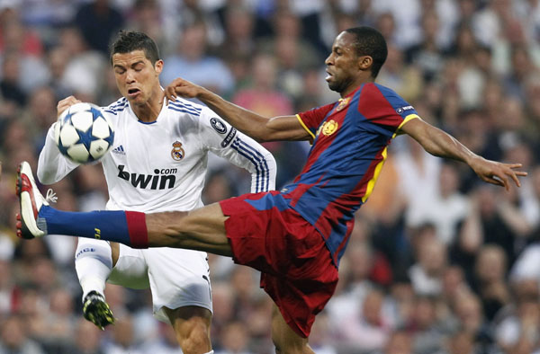 Real Madrid's Cristiano Ronaldo (L) challenges against Barcelona's Seydou Keita during their Champions League semi-final first leg soccer match at Santiago Bernabeu stadium in Madrid April 27, 2011. (Xinhua/Reuters Photo)