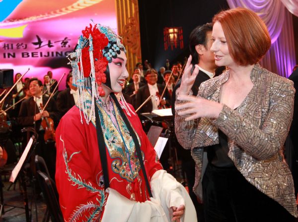 Australian Prime Minister Julia Gillard (R, front) talks with a performer after an evening gala in Beijing, capital of China, April 27, 2011. 
