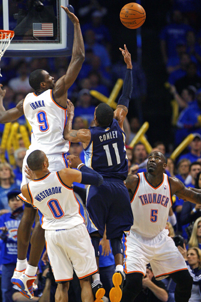 Oklahoma City Thunder center Serge Ibaka (top L) of the Republic of Congo blocks Memphis Grizzlies' guard Mike Conley (11) during the second half of Game 1 of the second round of the Western Conference NBA basketball playoffs in Oklahoma City, Oklahoma, May 1, 2011. 