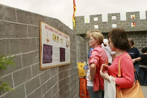 Visitors watch posts displaying four great ancient inventions of China during the 2011 Houston International Festival in Houston, the United States, April 30, 2011. The 2011 Houston International Festival opened here Friday, with an emphasis on the ancient Silk Road trade route that links China, India, Turkey and other cultures.