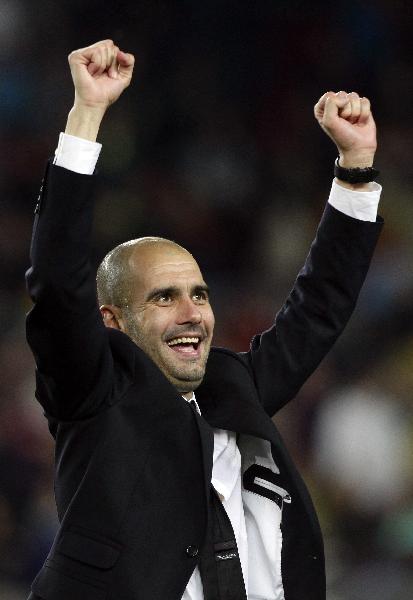 Barcelona's coach Pep Guardiola celebrates after qualifying for the final at the end of their Champions League semi-final second leg soccer match against Real Madrid at Nou Camp stadium in Barcelona, May 3, 2011.(Xinhua/Reuters Photo) 