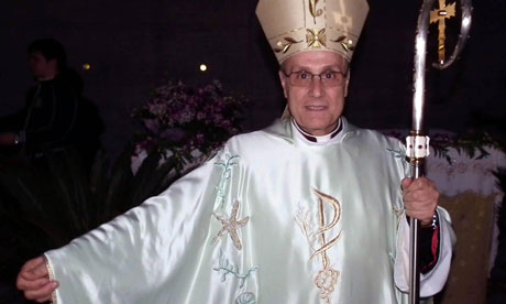Bishop Domenico Mogavero wears the silk robes designed by Giorgio Armani at mass on the Mediterranean island of Pantelleria. [Franco Lannino/EPA]