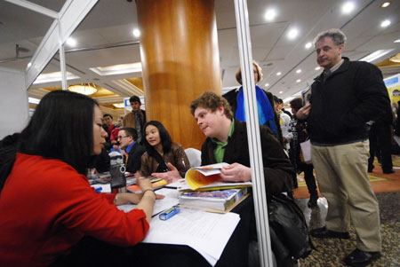 Job hunters talk to potential employers at a job fair for foreigners at the Hong Kong Macau Center in Beijing last year. 