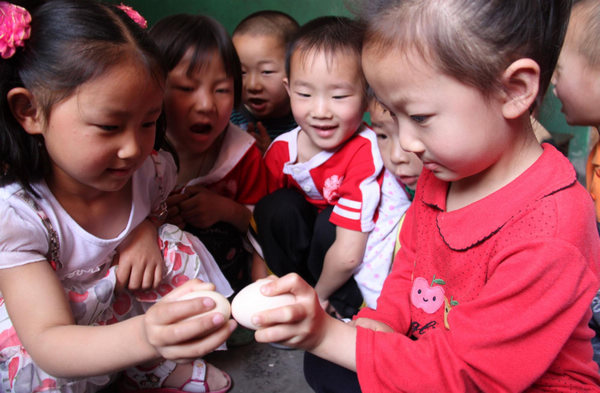 Children have a cracking time of egg fighting in Xichating village of Shiyan city in central China's Hubei Province, May 6, 2011, the day of summer begins (立夏). Many people in China boil an egg to take part in the tradition of egg fighting which heralds the start of summer in the Chinese lunar calendar, marking the transition of seasons.