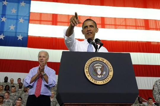 U.S. President Barack Obama speaks to troops at Fort Campbell in Kentucky May 6, 2011. Obama addressed several military units that have recently returned from duty in Afghanistan. Also during his visit, Obama privately thanked some members of the elite special forces team involved in the raid that killed Osama bin Laden. At left is Vice President Joe Biden. [Xinhua/Reuters]