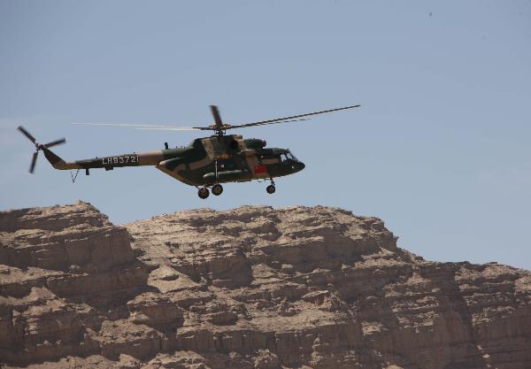 A helicopter takes part in a joint anti-terror drill in Kaxgar, northwest China's Xinjiang Uygur Autonomous Region, May 6, 2011. China, Kyrgyzstan and Tajikistan, all member states of the Shanghai Cooperation Organization (SCO), Friday conducted a joint anti-terror drill in Xinjiang, according to a statement issued by China's Ministry of Public Security. 