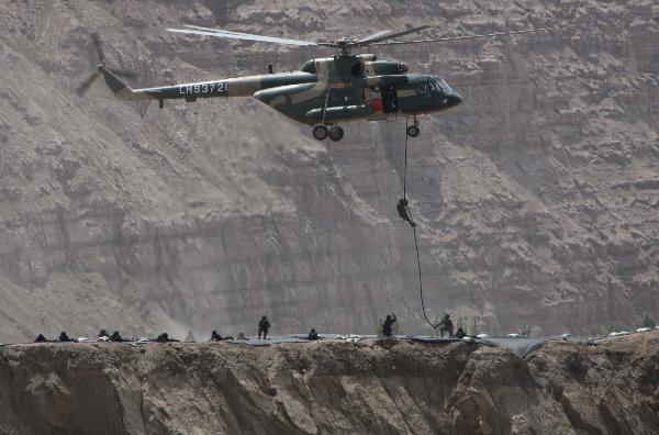 Members of armed police force take part in a joint anti-terror drill in Kaxgar, northwest China's Xinjiang Uygur Autonomous Region, May 6, 2011. China, Kyrgyzstan and Tajikistan, all member states of the Shanghai Cooperation Organization (SCO), Friday conducted a joint anti-terror drill in Xinjiang, according to a statement issued by China's Ministry of Public Security. 