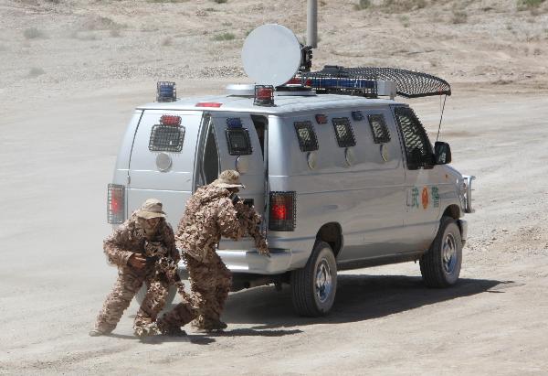 Members of armed police force take part in a joint anti-terror drill in Kaxgar, northwest China's Xinjiang Uygur Autonomous Region, May 6, 2011. China, Kyrgyzstan and Tajikistan, all member states of the Shanghai Cooperation Organization (SCO), Friday conducted a joint anti-terror drill in Xinjiang, according to a statement issued by China's Ministry of Public Security. 