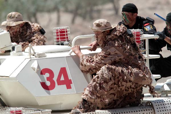 Members of armed police force take part in a joint anti-terror drill in Kaxgar, northwest China's Xinjiang Uygur Autonomous Region, May 6, 2011. China, Kyrgyzstan and Tajikistan, all member states of the Shanghai Cooperation Organization (SCO), Friday conducted a joint anti-terror drill in Xinjiang, according to a statement issued by China's Ministry of Public Security. 