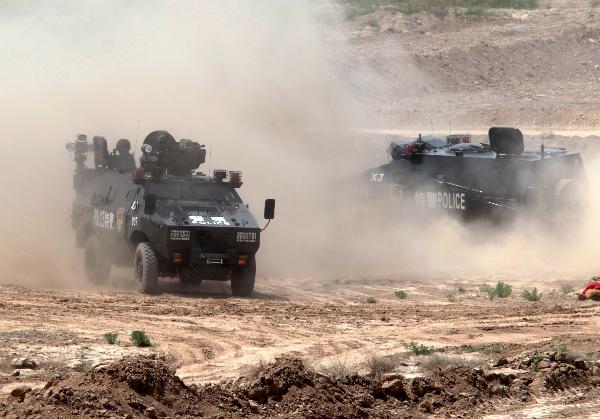 Members of armed police force take part in a joint anti-terror drill in Kaxgar, northwest China's Xinjiang Uygur Autonomous Region, May 6, 2011. China, Kyrgyzstan and Tajikistan, all member states of the Shanghai Cooperation Organization (SCO), Friday conducted a joint anti-terror drill in Xinjiang, according to a statement issued by China's Ministry of Public Security. 