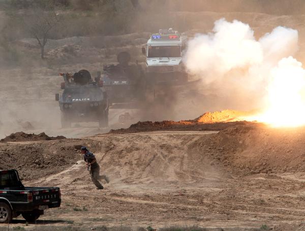 Armed vehicles are seen during joint anti-terror drill in Kaxgar, northwest China's Xinjiang Uygur Autonomous Region, May 6, 2011. China, Kyrgyzstan and Tajikistan, all member states of the Shanghai Cooperation Organization (SCO), Friday conducted a joint anti-terror drill in Xinjiang, according to a statement issued by China's Ministry of Public Security. 