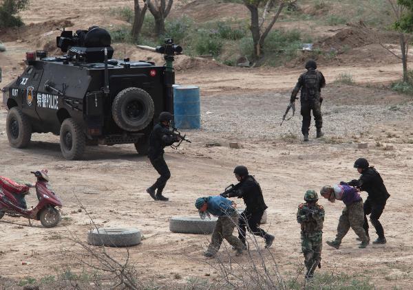 Members of armed police force take part in a joint anti-terror drill in Kaxgar, northwest China's Xinjiang Uygur Autonomous Region, May 6, 2011. China, Kyrgyzstan and Tajikistan, all member states of the Shanghai Cooperation Organization (SCO), Friday conducted a joint anti-terror drill in Xinjiang, according to a statement issued by China's Ministry of Public Security. 