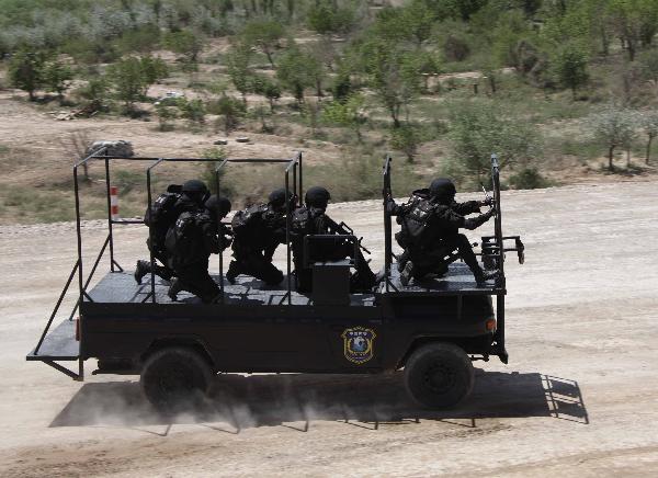 Members of armed police force take part in a joint anti-terror drill in Kaxgar, northwest China's Xinjiang Uygur Autonomous Region, May 6, 2011. China, Kyrgyzstan and Tajikistan, all member states of the Shanghai Cooperation Organization (SCO), Friday conducted a joint anti-terror drill in Xinjiang, according to a statement issued by China's Ministry of Public Security. 