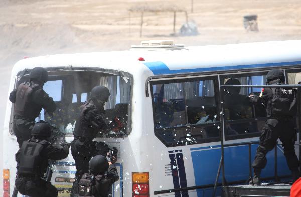 Armed police officials take part in a joint anti-terror drill in Kaxgar, northwest China's Xinjiang Uygur Autonomous Region, May 6, 2011. China, Kyrgyzstan and Tajikistan, all member states of the Shanghai Cooperation Organization (SCO), Friday conducted a joint anti-terror drill in Xinjiang, according to a statement issued by China's Ministry of Public Security. 