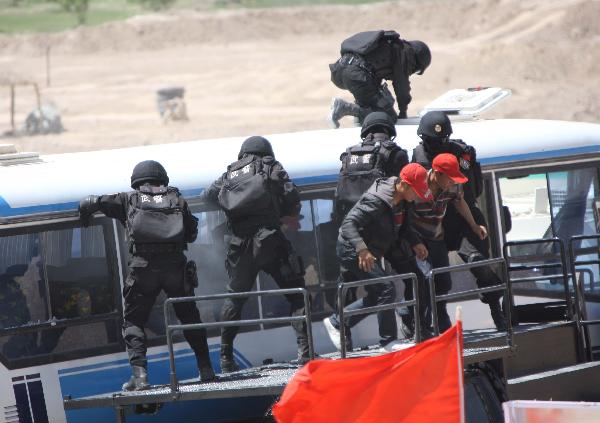 Members of armed police force take part in a joint anti-terror drill in Kaxgar, northwest China's Xinjiang Uygur Autonomous Region, May 6, 2011. China, Kyrgyzstan and Tajikistan, all member states of the Shanghai Cooperation Organization (SCO), Friday conducted a joint anti-terror drill in Xinjiang, according to a statement issued by China's Ministry of Public Security. 