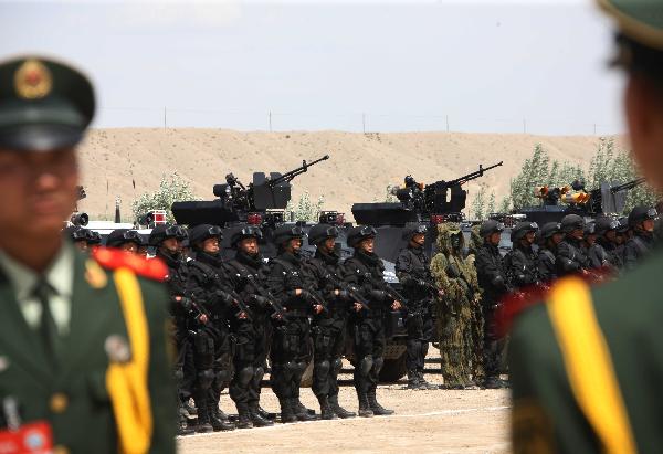 Members of armed police force wait for inspection during a joint anti-terror drill in Kaxgar, northwest China's Xinjiang Uygur Autonomous Region, May 6, 2011. China, Kyrgyzstan and Tajikistan, all member states of the Shanghai Cooperation Organization (SCO), Friday conducted a joint anti-terror drill in Xinjiang, according to a statement issued by China's Ministry of Public Security.