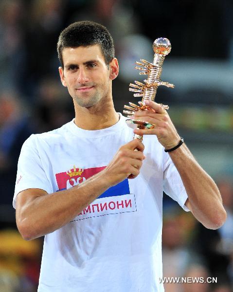 Novak Djokovic poses with the trophy during the awarding ceremony for men's singles at the Madrid Open tennis tournament in Madrid, capital of Spain, on May 8, 2011. Djokovic beat Rafael Nadal 2-0 to win the champions. (Xinhua/Chen Haitong) 