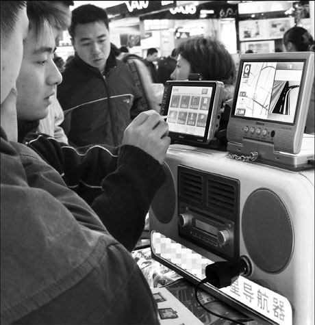 A salesman demonstrates how to operate the Beidou navigation system for drivers at a trade market in Ningbo, in East China's Zhejiang province. As part of its efforts to establish an independent satellite navigation system, in 2000 the Chinese government launched the first Beidou system, which is to offer services to customers across the Asia-Pacific region by 2012 and globally by 2020. [China Daily]