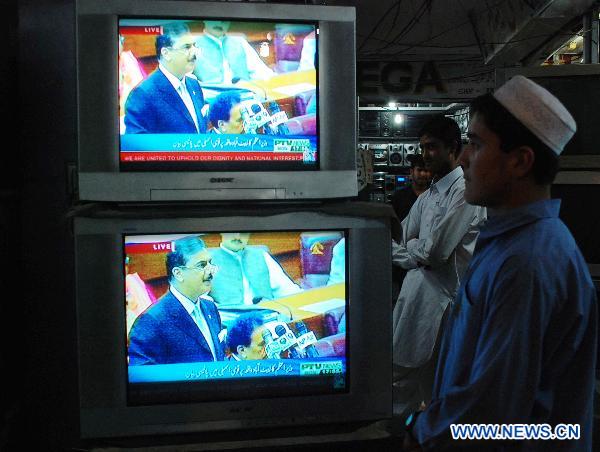 A Pakistani watches the television broadcasting the address of Pakistan's Prime Minister Yusuf Raza Gilani in northwest Pakistan's Peshawar on May 9, 2011. Pakistani Prime Minister Yusuf Raza Gilani on Monday told the parliament that investigation has been ordered into the presence of Osama bin Laden in the city of Abbottabad. [Xinhua]