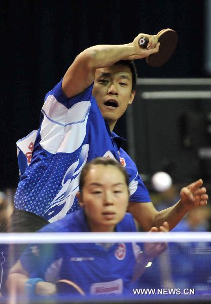 Tang Peng (Rear) and Tie Yana from China's Hong Kong compete in the first round match of mixed doubles against Andre Silva and Maria Xiao of Portugal in the 2011 World Table Tennis Championships (WTTC) in Rotterdam, the Netherlands, May 9, 2011. Tang Peng and Tie Yana won with 3:1. [Wu Wei/Xinhua]
