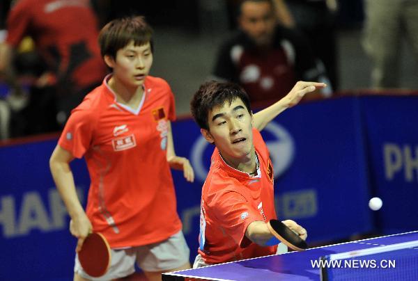Yan An (R) and Feng Yalan from China compete in the first round match of mixed doubles against Robert Floras and Antonina Szymanska of Poland in the 2011 World Table Tennis Championships (WTTC) in Rotterdam, the Netherlands, May 9, 2011. Yan An and Feng Yalan won with 4:2. [Wu Wei/Xinhua]