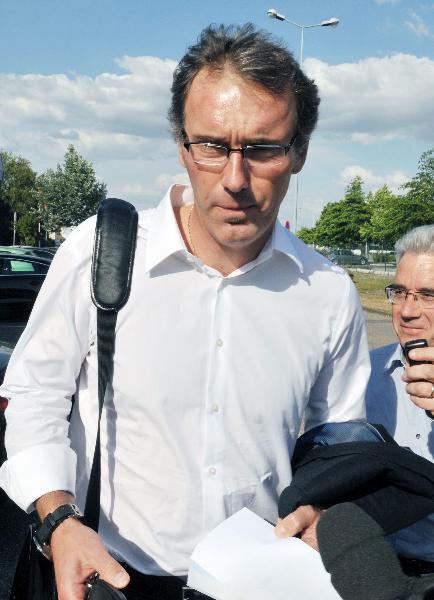 France's national team soccer coach Laurent Blanc receives interviews while leaving Merignac's airport, near Bordeaux southwestern France, May 7, 2011, before two inquiries set up by the ministry and federation. 