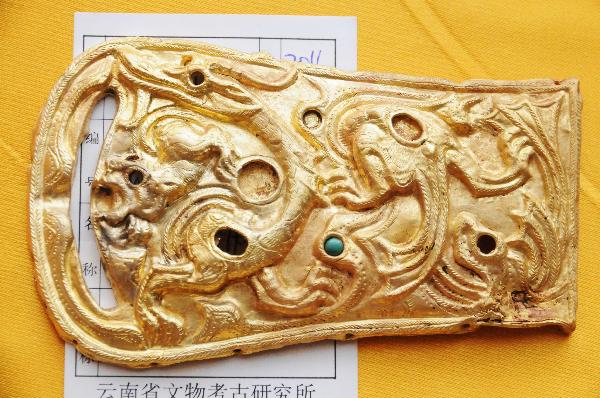 Photo taken on May 9, 2011, shows a gold buckle with dragon and tiger designs unearthed in an ancient noble tomb in Guangnan County, southwest China's Yunnan Province. The Yunnan provincial archaeological institute and the Guangnan government on Monday jointly announced that the tombs discovered in Heizhiguo Township of Guangnan County are and even royal tombs of the ancient Gouding kingdom under the rule of the Han Dynasty (202 BC-220 AD).