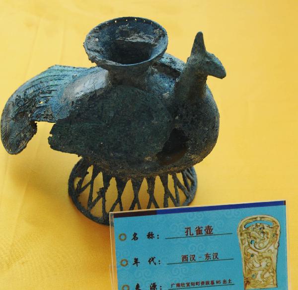 Photo taken on May 9, 2011, shows a bronze peacock-shaped pot unearthed in an ancient noble tomb in Guangnan County, southwest China's Yunnan Province. 