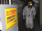 Workers measure radiation levels at Fukushima plant