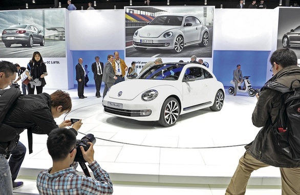 A visitor examines a newly released Volkswagen AG Beetle on display at the Auto Shanghai 2011 show. China's vehicle imports in March hit a new record of 97,900 units, according to statistics from the General Administration of Customs. 