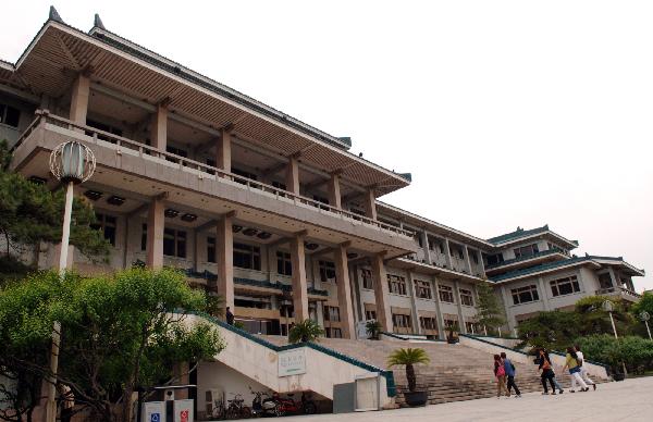 Readers enter the southern component of the National Library of China in Beijing on May 9, 2011. 