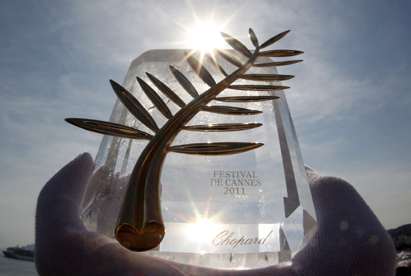 A Chopard representative displays the Palme d'Or, the highest prize awarded to competing films, in Cannes May 10, 2011. The Cannes film festival runs from May 11 to 22.