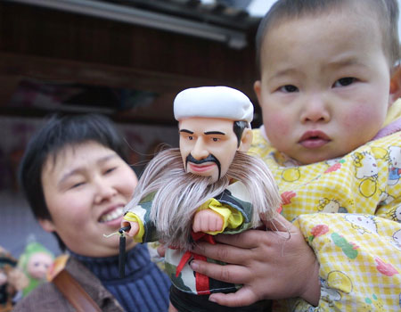 A baby holds a Osama bin Laden toy in Hangzhou, Zhejiang Province.