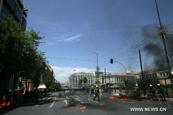 Greek demonstrators clash with anti-riot police during a march against austerity measures in central Athens, capital of Greece, May 11, 2011. The two umbrella labor unions of private and public sector employees GSEE and ADEDY staged the second nationwide 24-hour general strike this year over austerity policies implemented to tackle an acute debt crisis. [Xinhua]