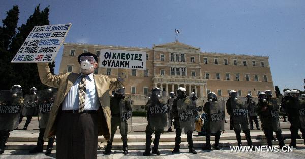 Greek demonstrators stage a protest against austerity measures in central Athens, capital of Greece, May 11, 2011. The two umbrella labor unions of private and public sector employees GSEE and ADEDY staged the second nationwide 24-hour general strike this year over austerity policies implemented to tackle an acute debt crisis. [Xinhua]