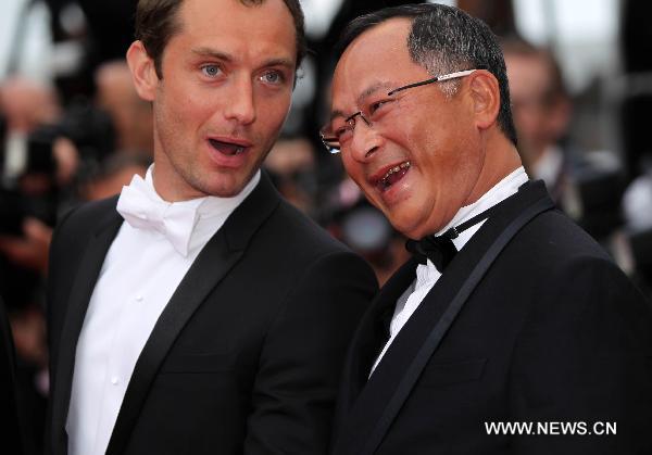 Jury members Jude Law (L) and Johnnie To pose before the opening of the 64th Cannes Film Festival in Cannes, France, on May 11, 2011.