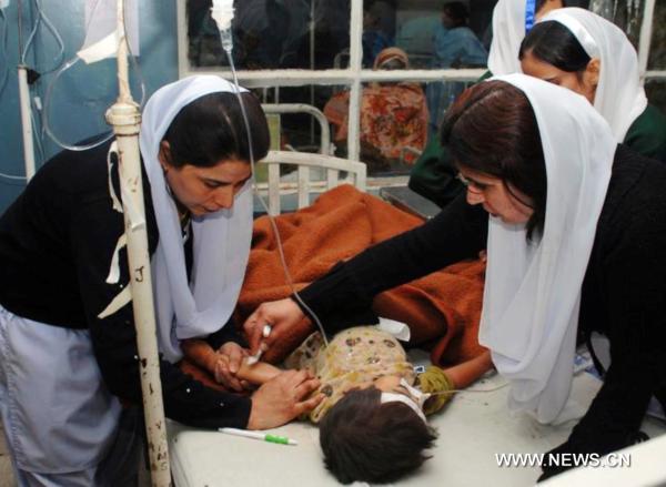 Pakistani nurses give first aid treatment to a child at a hospital on the occasion of International Nursing Day in southwest Pakistan's Quetta, on May 12, 2011. International Nursing Day is marked on Thursday across the world with the theme 'Closing The Gap: Increasing Access and Equity'. [Xinhua/Hassan]