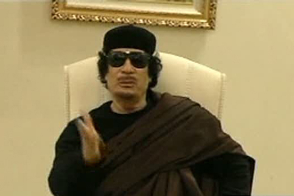 Muammar Gaddafi gestures as he speaks at a Tripoli hotel in this still image from a video by Libyan TV released May 11, 2011. Libyan state television showed footage of Gaddafi meeting officials in the hotel, ending nearly two weeks of doubt over his fate since a NATO air strike killed his son. [Xinhua/Reuters Photo]