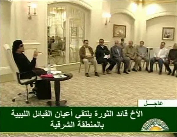 Muammar Gaddafi (L) gestures as he speaks to officials at a Tripoli hotel in this still image from a video by Libyan TV released May 11, 2011. [Xinhua/Reuters Photo]